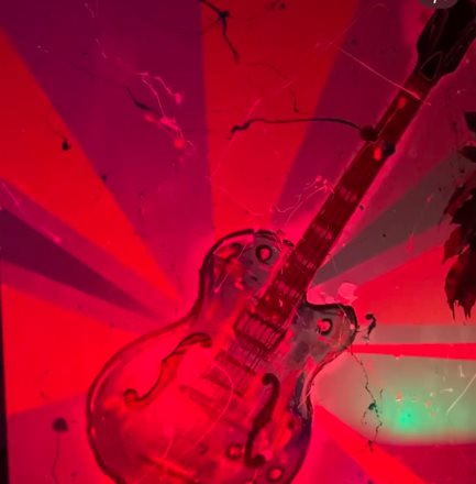 Gretsch — a physical painting of an electric guitar, performing under authored light